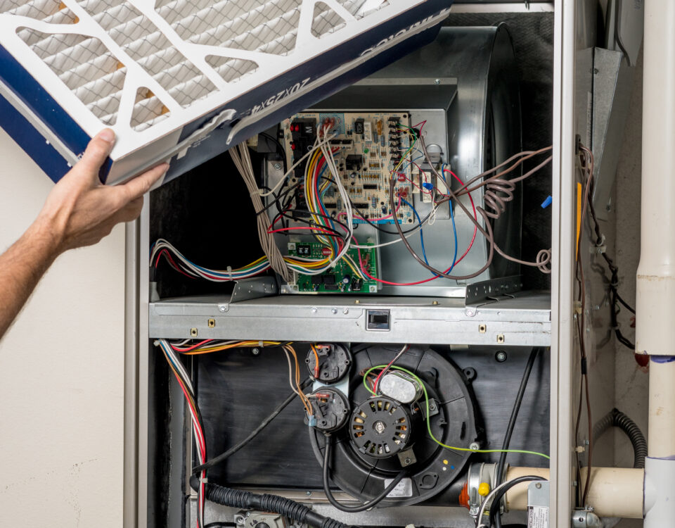 New,Clean,Filter,Is,Being,Inserted,Into,A,Home,Furnace